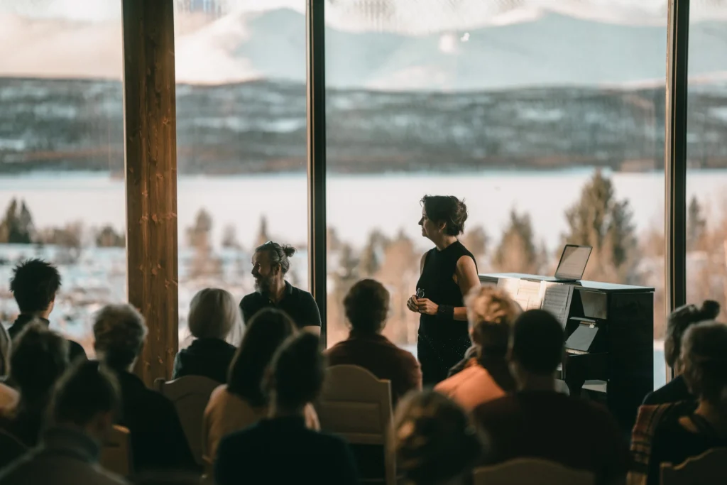 Musicians performing with scenic backdrop.